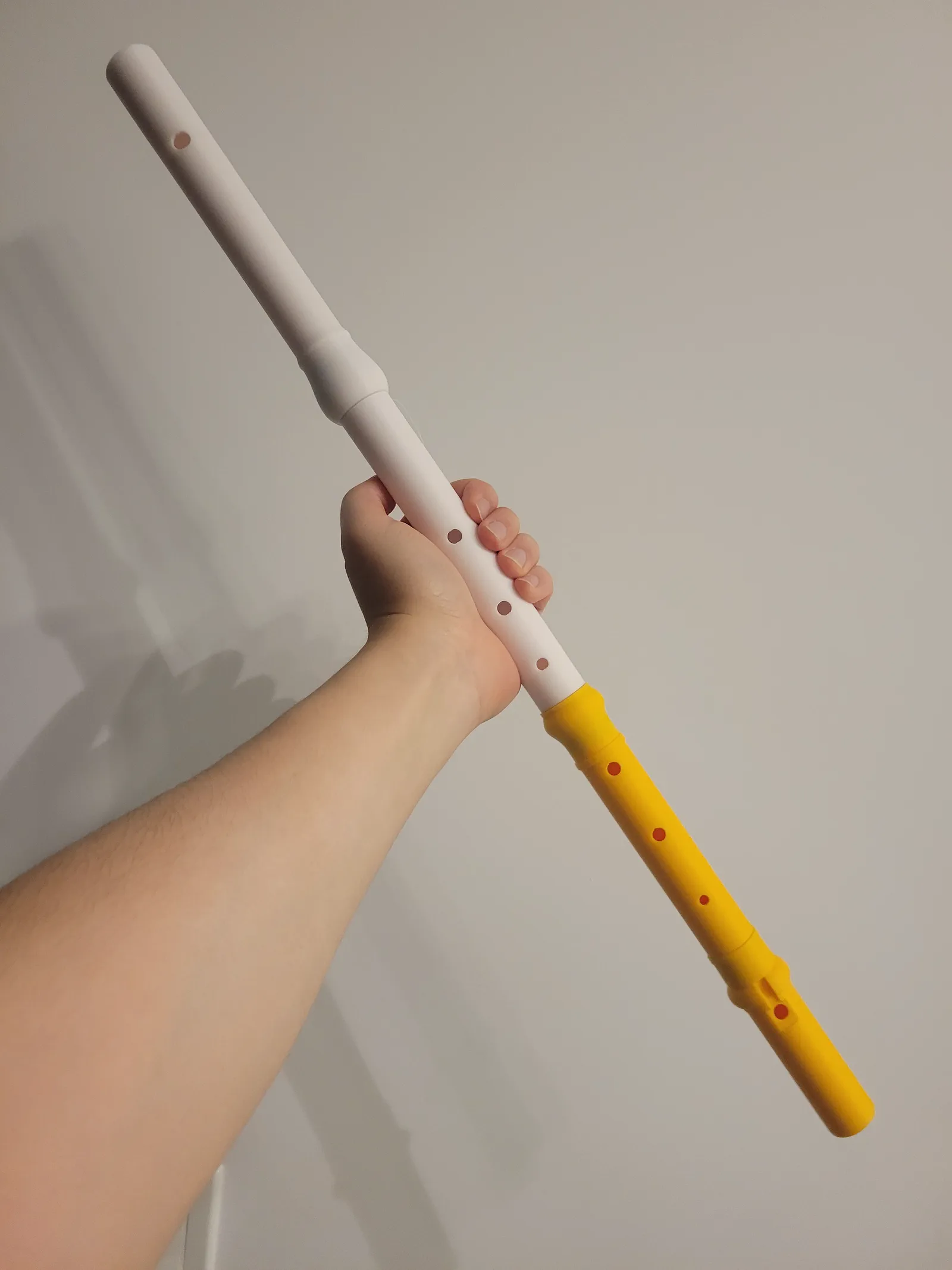 Two-tone 3D-printed recorder held in hand